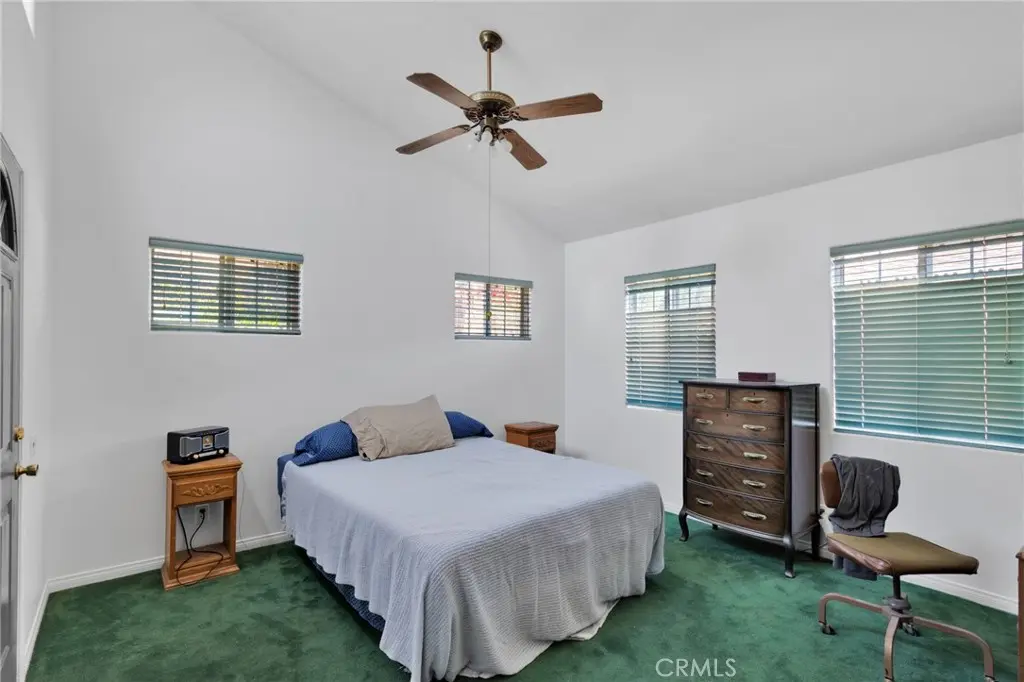 Primary bedroom with vaulted ceiling